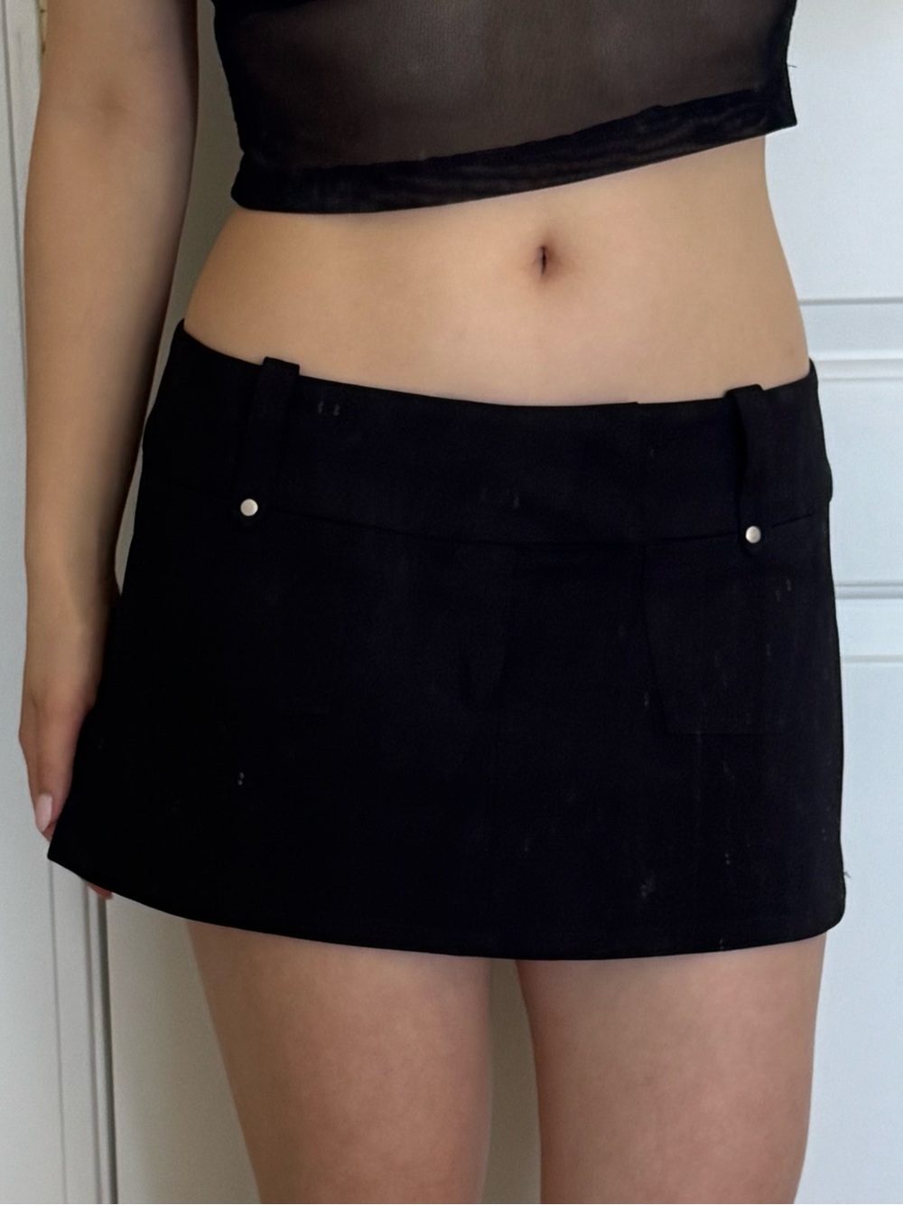 Black low waisted mini skirt with belt loops from I am Gia
